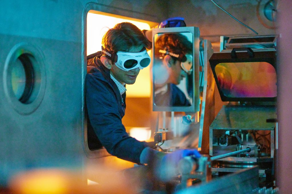 Researcher operating laser technology at the Central Laser Facility